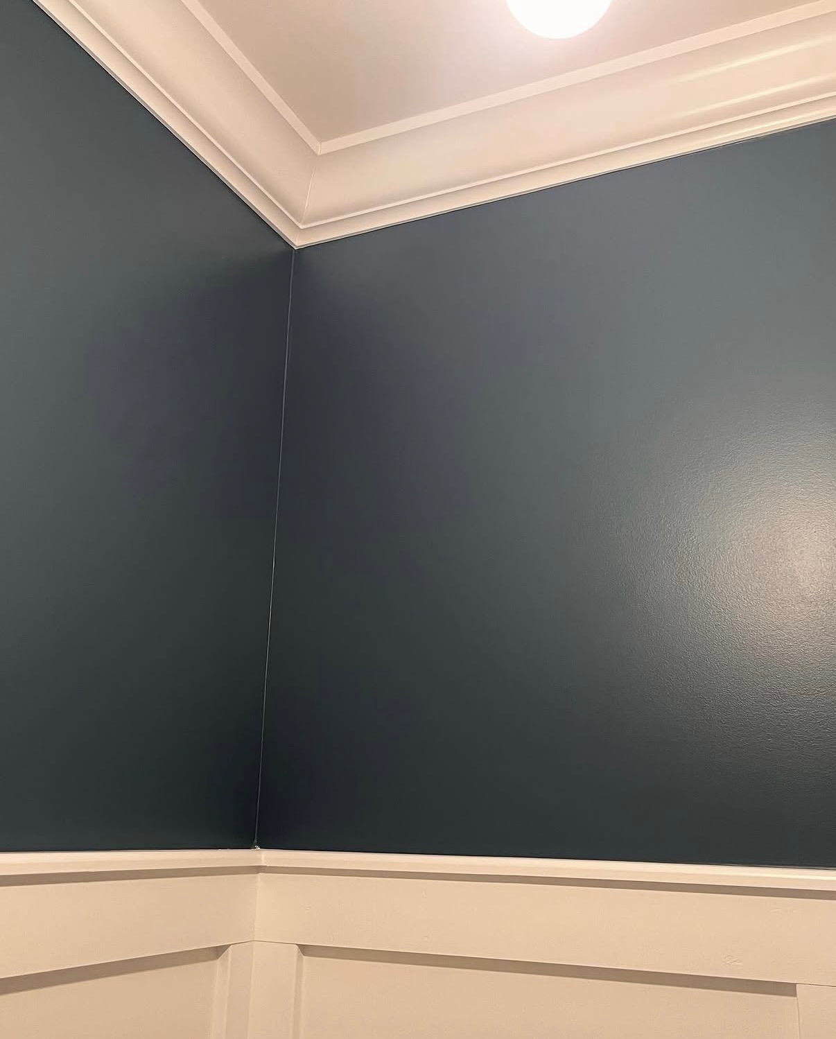 Dark painted wall with white trim