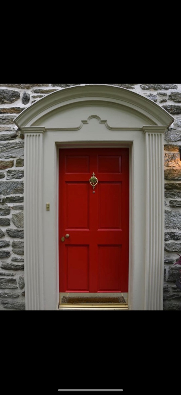 Red painted front door and white surround
