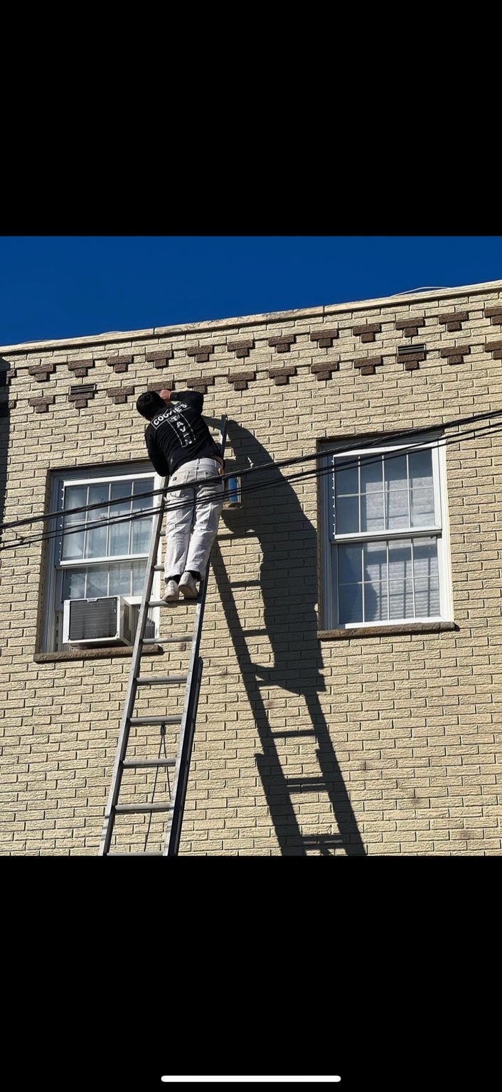 Painter completing exterior brick detail work